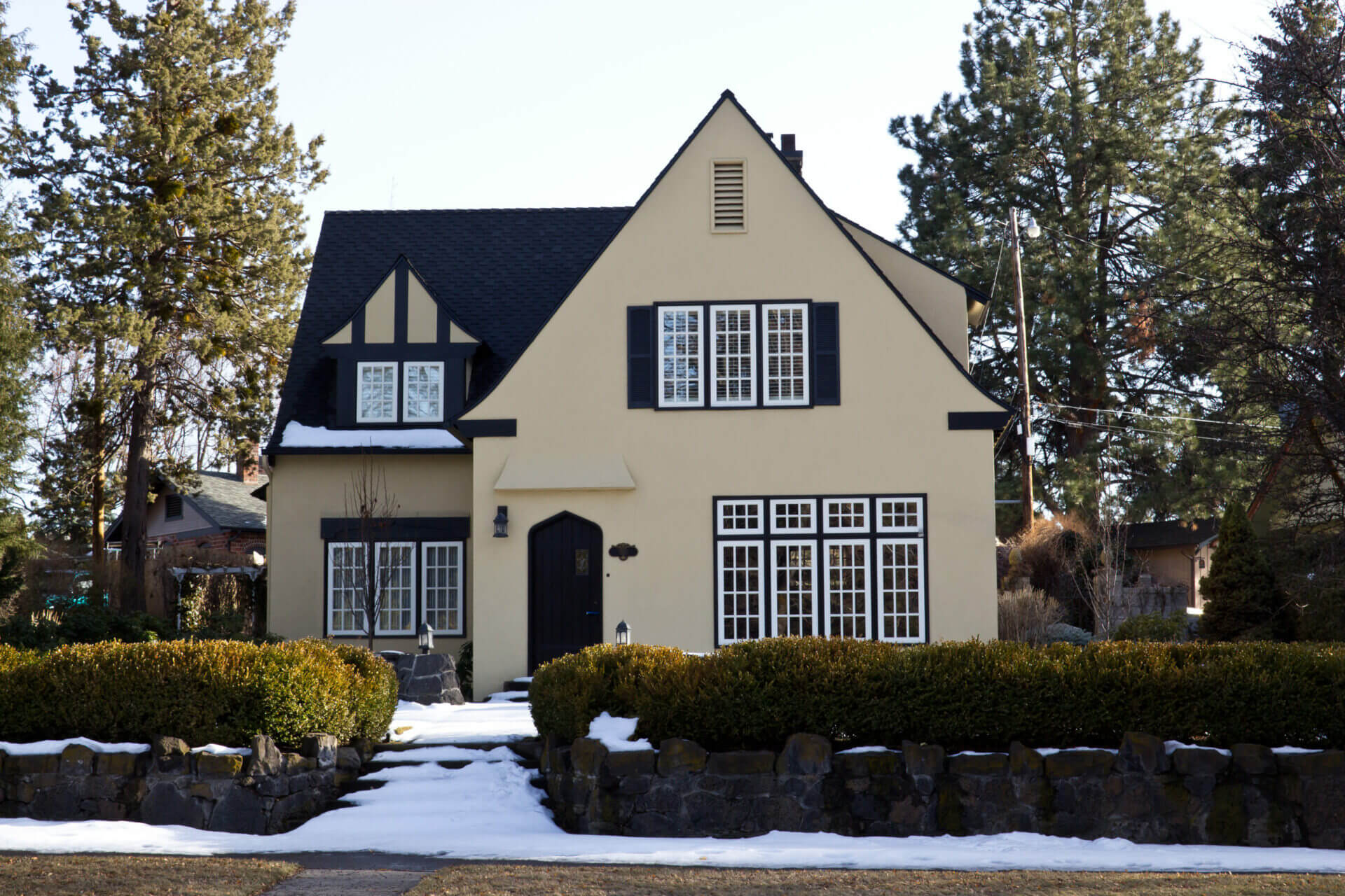 Professional house painter applying residential paint to home exterior walls