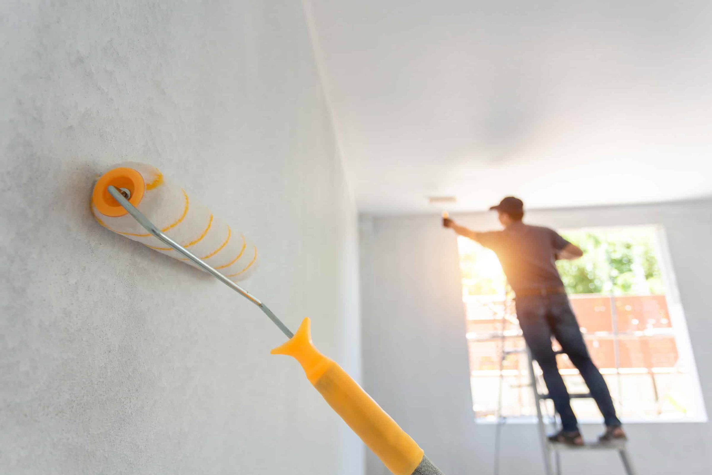 Professional interior painter applying fresh paint to residential room walls in Ocala